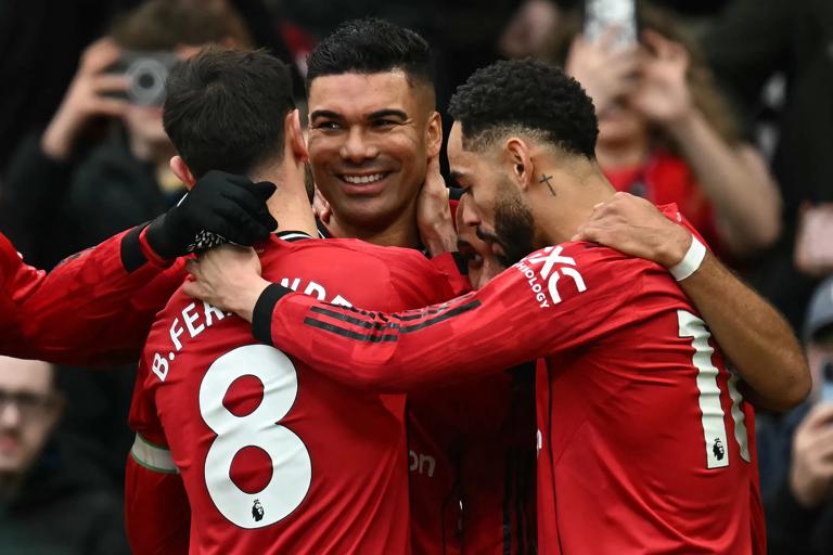 Manchester United's Brazilian midfielder #18 Casemiro (C) celebrates with teammates after scoring the team's first goal during the English Premier League football match between Manchester United and Fulham at Old Trafford in Manchester, north west England, on February 1, 2026. (Photo by Paul ELLIS / AFP via Getty Images) / RESTRICTED TO EDITORIAL USE. No use with unauthorized audio, video, data, fixture lists, club/league logos or 'live' services. Online in-match use limited to 120 images. An additional 40 images may be used in extra time. No video emulation. Social media in-match use limited to 120 images. An additional 40 images may be used in extra time. No use in betting publications, games or single club/league/player publications. / 
