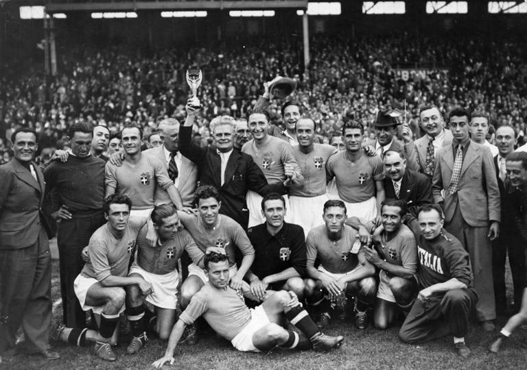 19.06.1938, Italy players and staff celebrate winning the tournament after defeating Hungary in the final in Colombes. From left to right, back row: Luigi Burlando (assistant coach), Amedeo Biavati, Giorgio Vaccaro (FIGC president), Vittorio Pozzo (with trophy), Guido Angeli (physio), Silvio Piola, Giovanni Ferrari, Gino Colaussi. Front row: Ugo Locatelli, Giuseppe Meazza, Alfredo Foni, Pietro Serantoni (crouched), Aldo Olivieri, Pietro Rava, Michele Andreolo, Amedeo Bortolotti (physio).