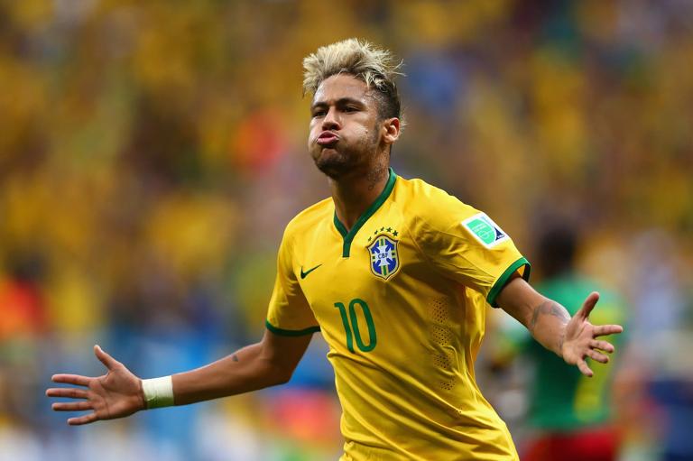 BRASILIA, BRAZIL - JUNE 23: Neymar of Brazil celebrates scoring his team's second goal and his second of the game during the 2014 FIFA World Cup Brazil Group A match between Cameroon and Brazil at Estadio Nacional on June 23, 2014 in Brasilia, Brazil.  (Photo by Clive Brunskill/Getty Images)